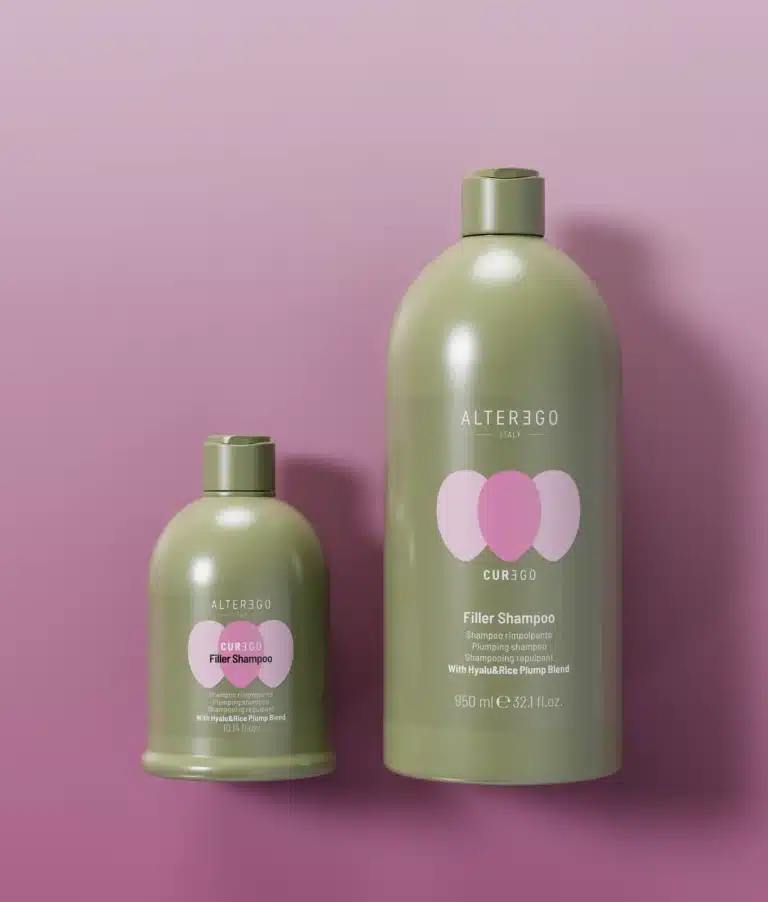 Two bottles of Alter Ego Italy Curego Filler Shampoo against a pink background.