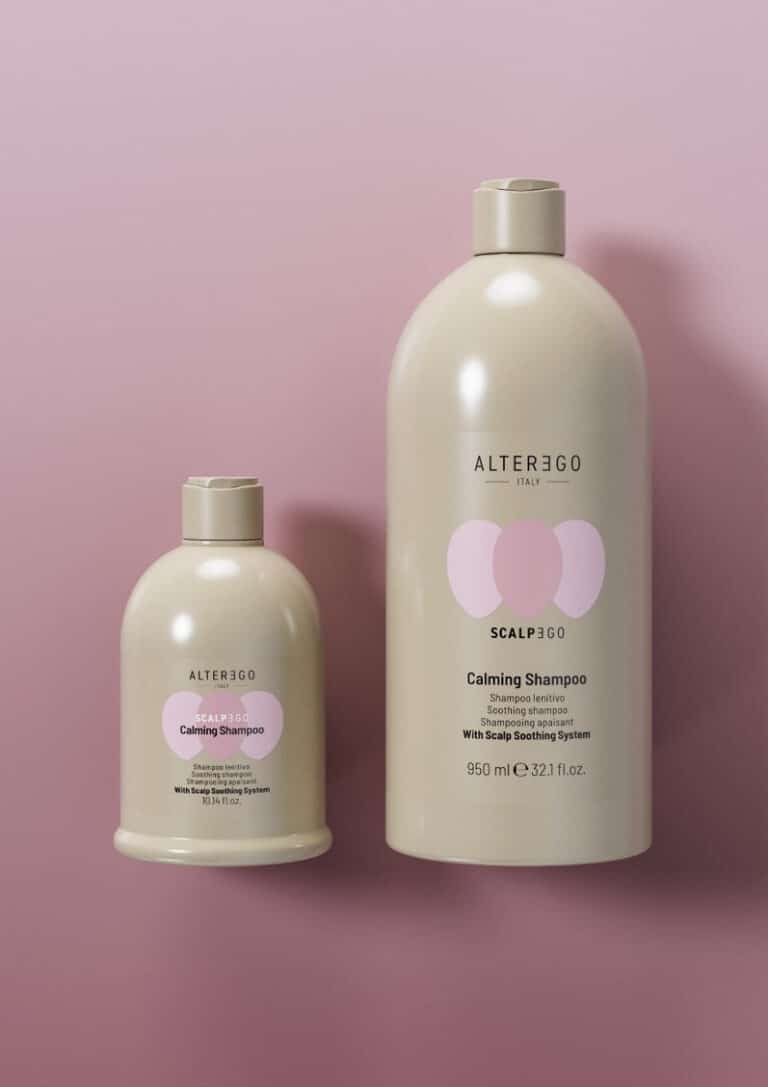 Two bottles of Alter Ego Italy Scalp3go Calming Shampoo on a pink background.